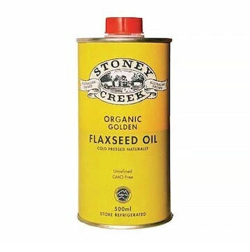 A 500ml yellow metal can of Stoney Creek Organic Golden Flaxseed Oil with a red cap, shown on a plain white background.